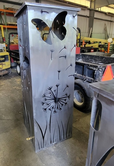 Custom metal fabrication with butterfly and dandelion cutouts